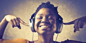 Girl listening to headphones smiling