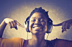 Girl listening to headphones smiling